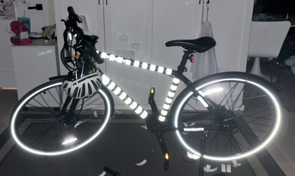 Bike at night shining with white stripes reflecting brightly 