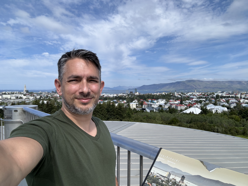 A selfie taken from the top of the perlan museum with a deep view of the  skyline