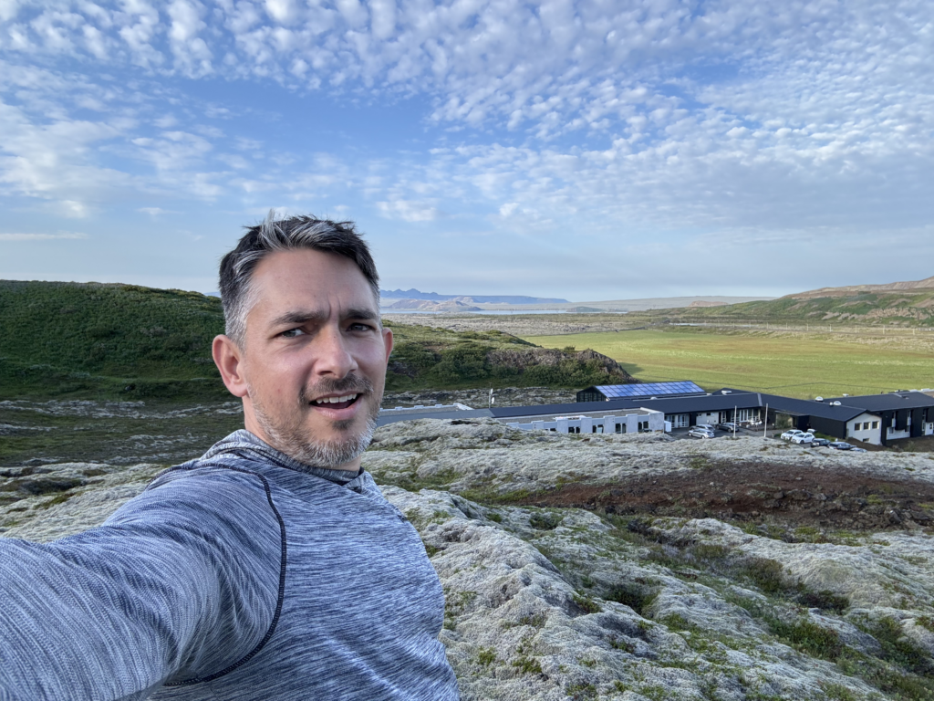 matt selfie against a deep iceland view with a blue sky all the way out to a bay