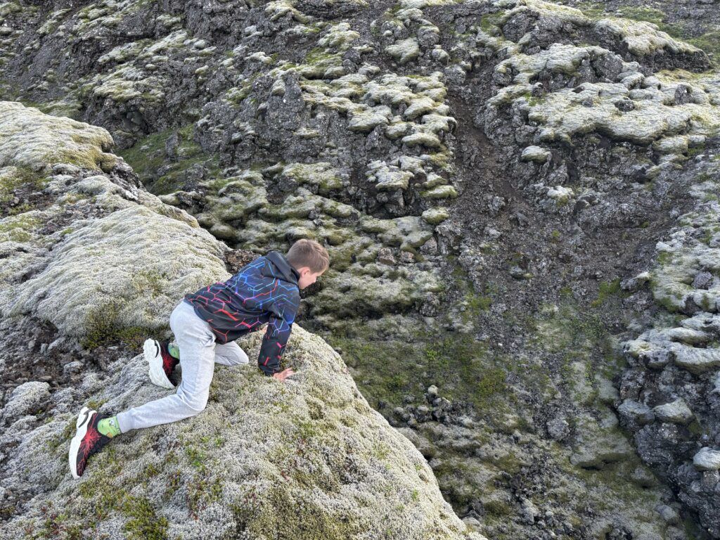 max staring over the edge of a cliff into a gorge