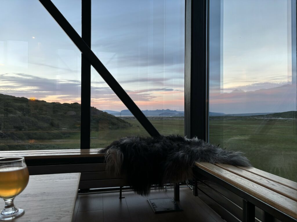 a gorgeous sunset through huge windows with a icelandic rocky landscape.