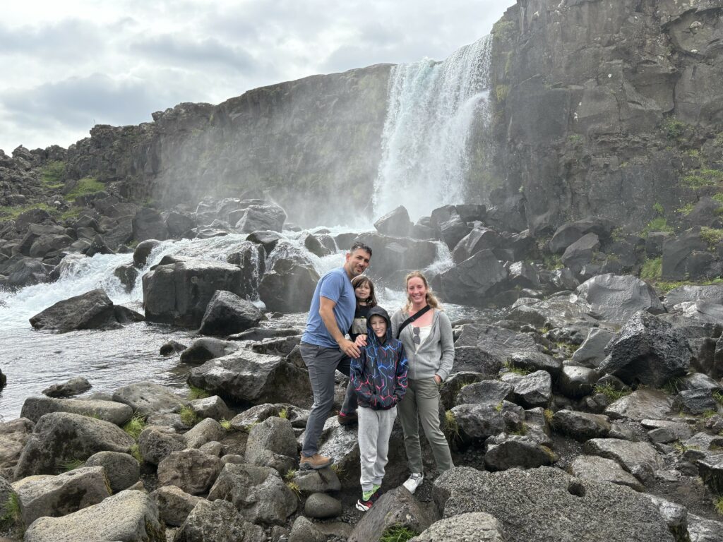 Katz family portrait by a waterfall