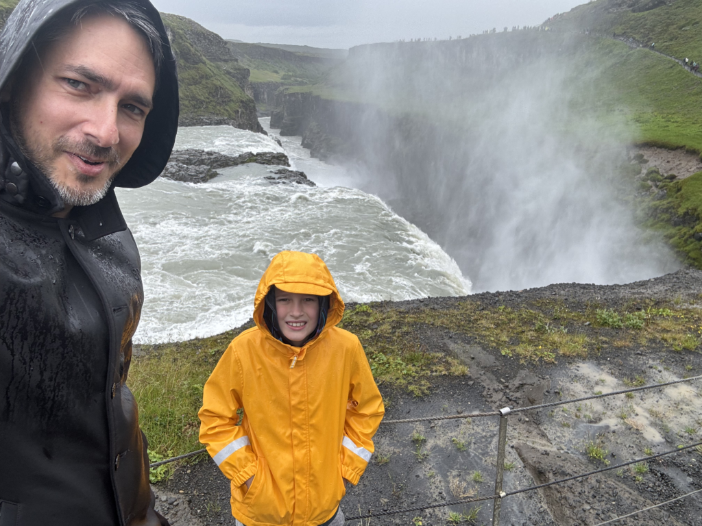 Matt and Max selfie as the gullfoss rushes over and into a deep canyon