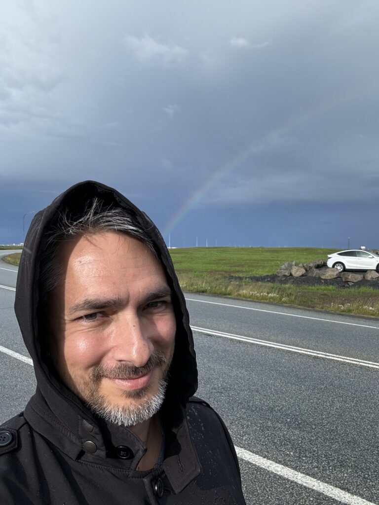 Matt grinning with a rainbow coming out of his head.